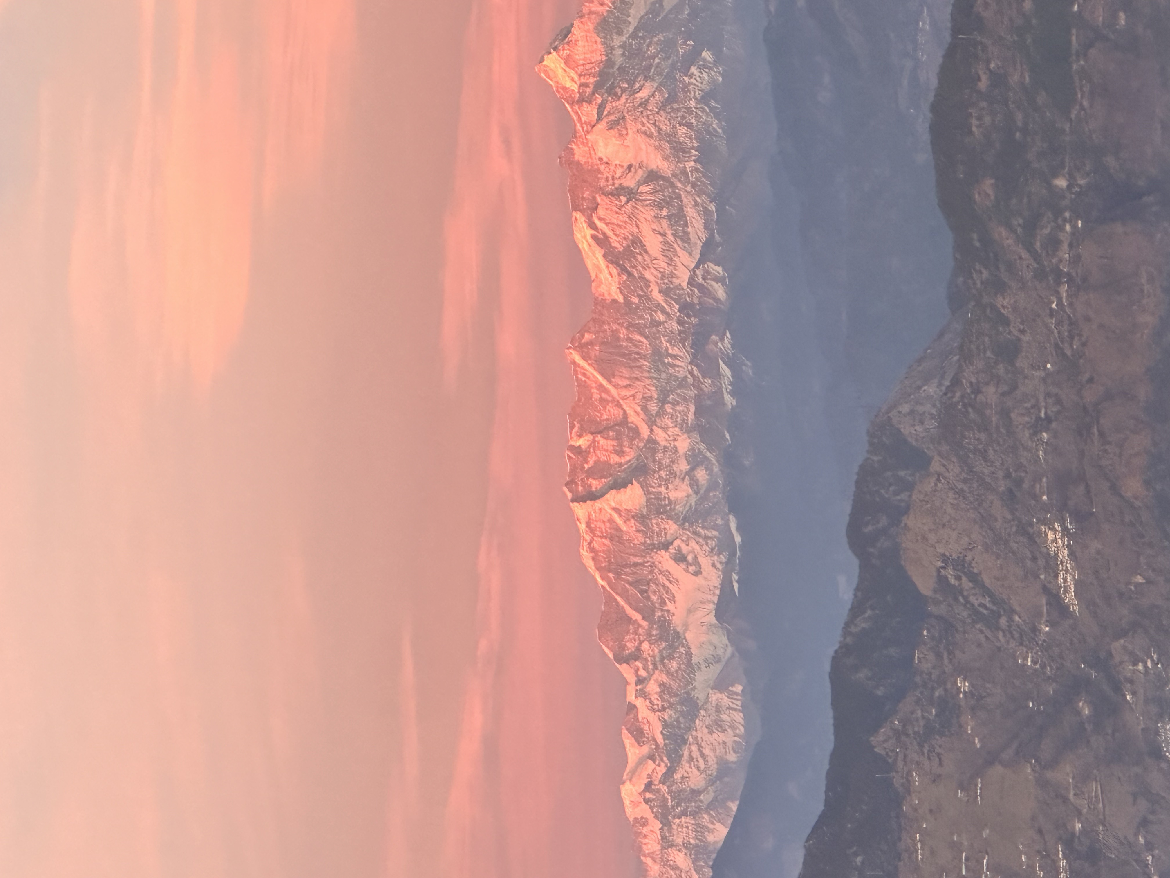 Gangotri Range in the Himalayas bathed in pink sunset light